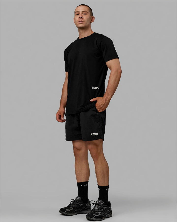 Man wearing Millenium 7" Shorts - Black