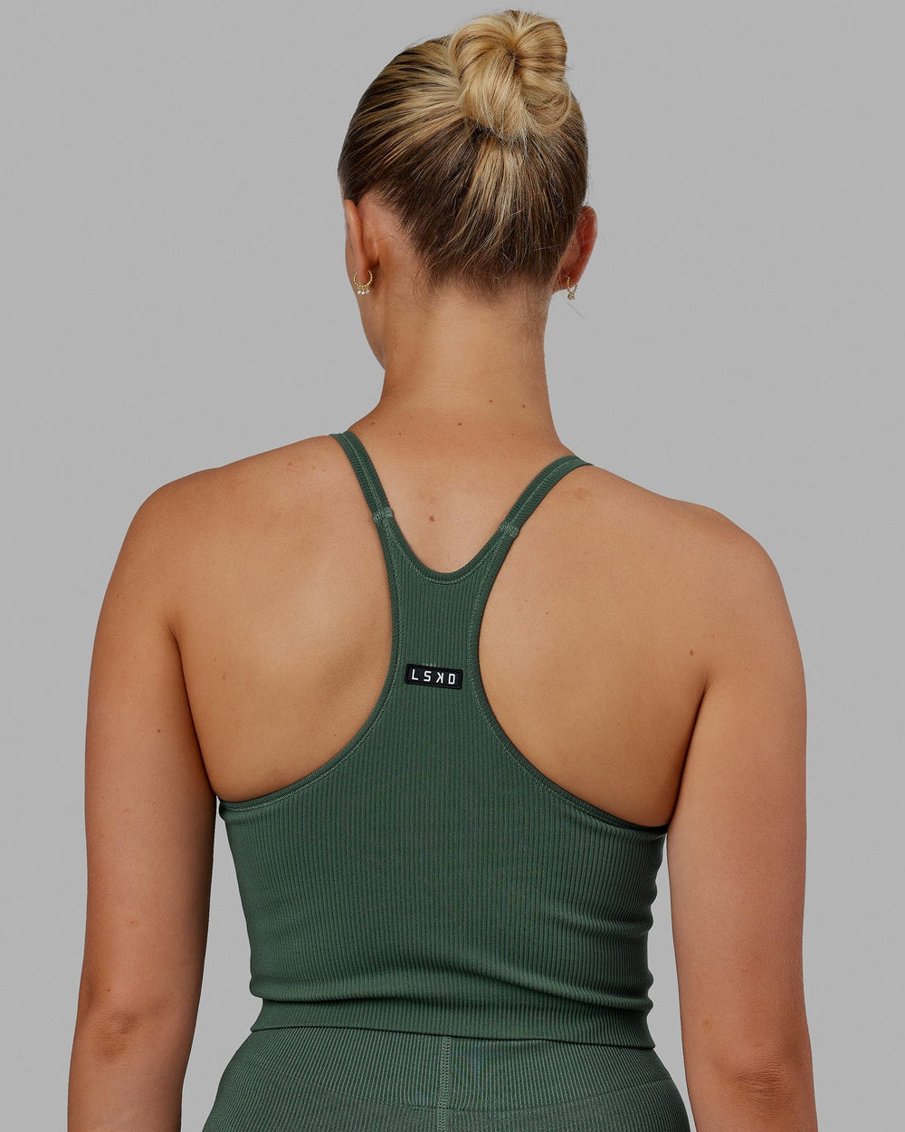 Woman wearing Minimal Seamless Crop Ribbed Tank - Dark Forest