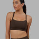 Woman wearing Momentum Ribbed Sports Bra - Dark Chocolate