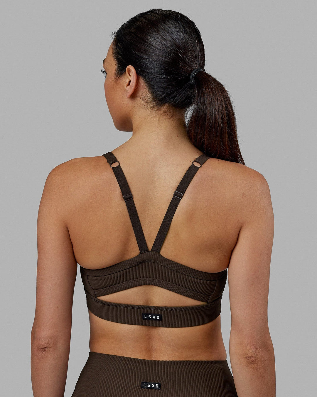 Woman wearing Momentum Ribbed Sports Bra - Dark Chocolate