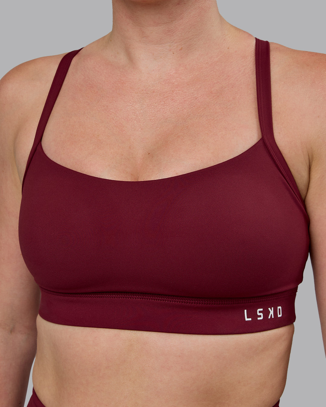 Woman wearing Momentum Sports Bra (D/DD/E) - Cordovan