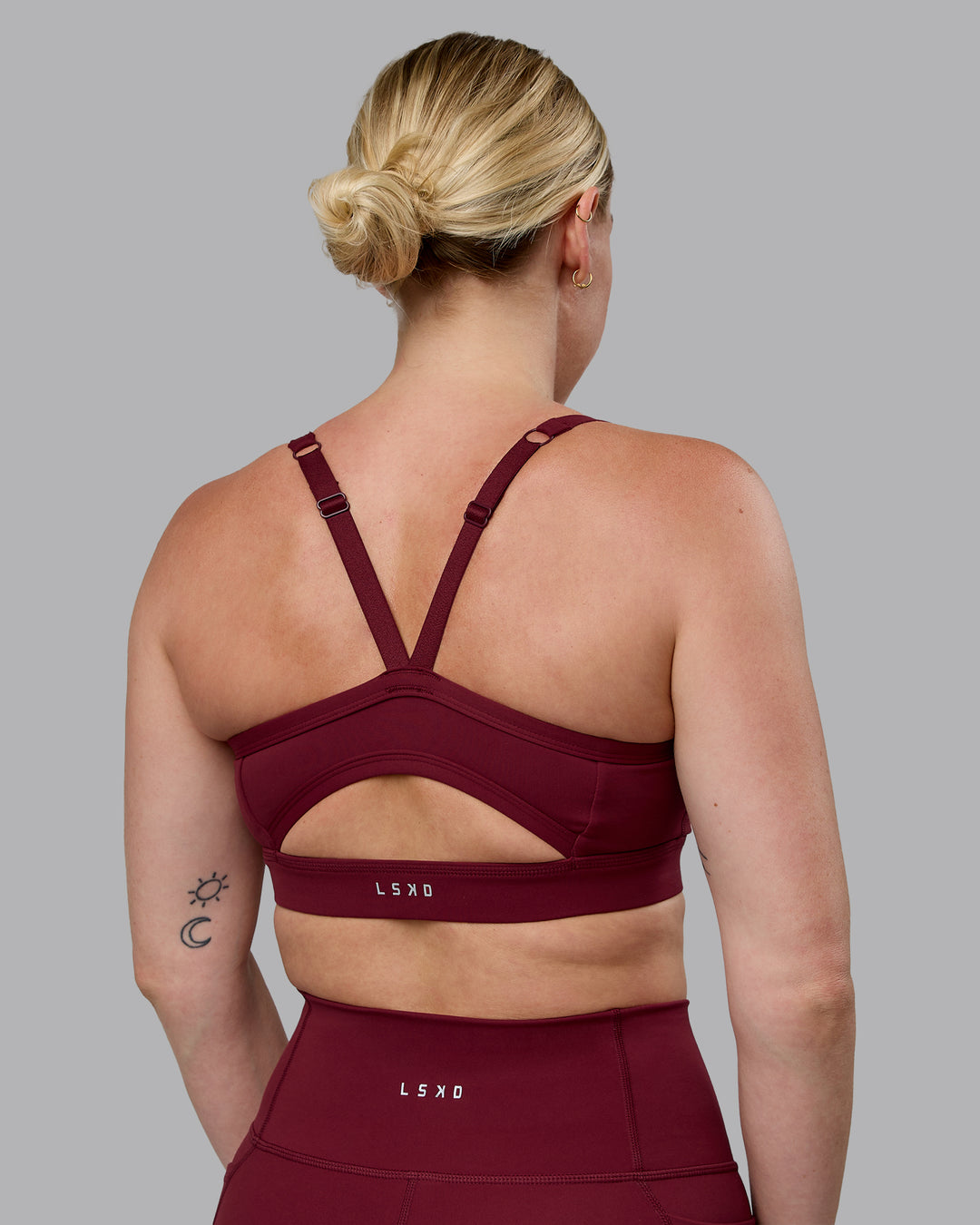 Woman wearing Momentum Sports Bra (D/DD/E) - Cordovan