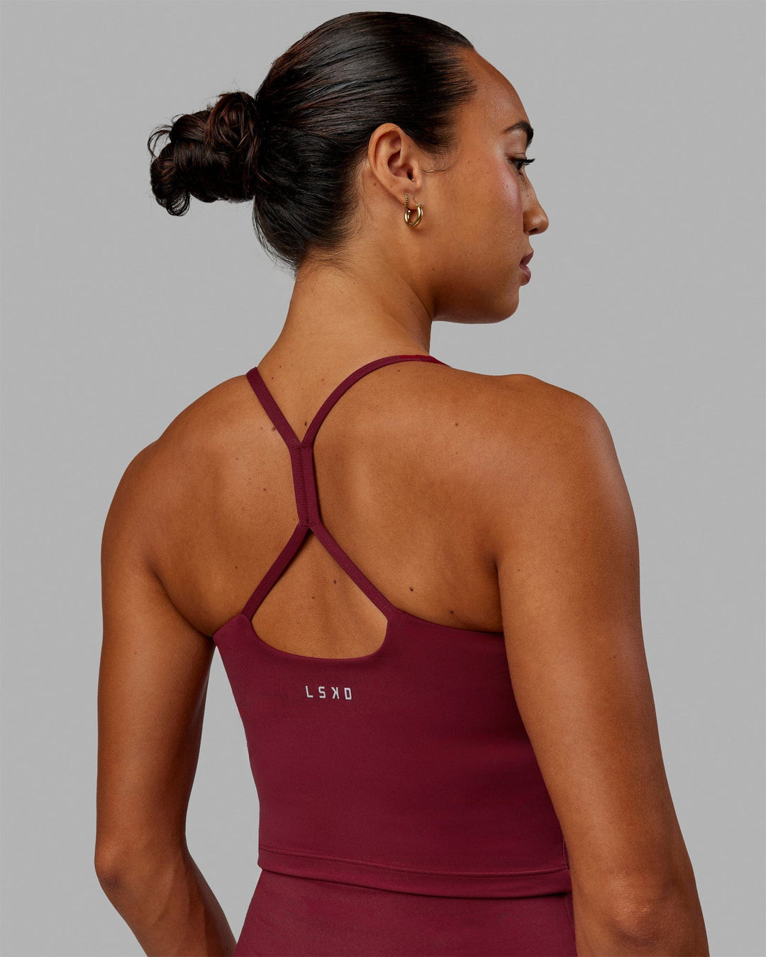 Woman wearing Movement Active Tank - Cranberry