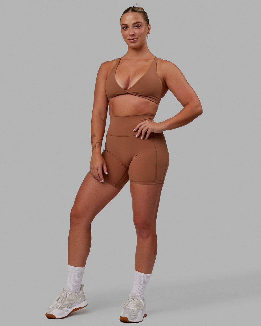 Woman wearing Nimble Sports Bra - Brick