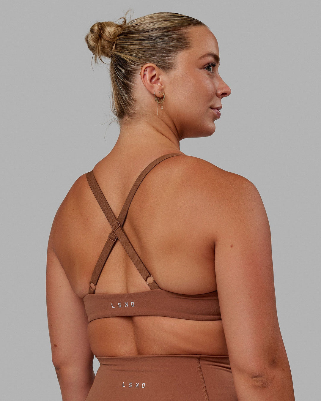Woman wearing Nimble Sports Bra - Brick