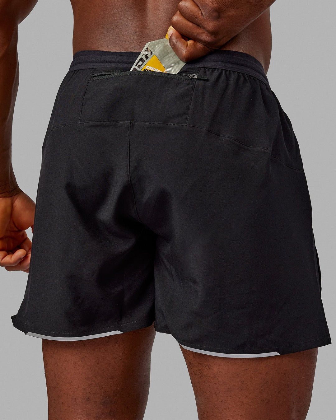 Man wearing Pace 5" Lined Performance Shorts - Black-Reflective