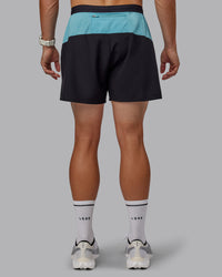 Man wearing Pace 5" Lined Performance Shorts - Black-Retro Blue