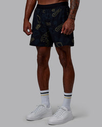 Man wearing Patty Mills Challenger 6" Performance Shorts - Black-Vital Green
