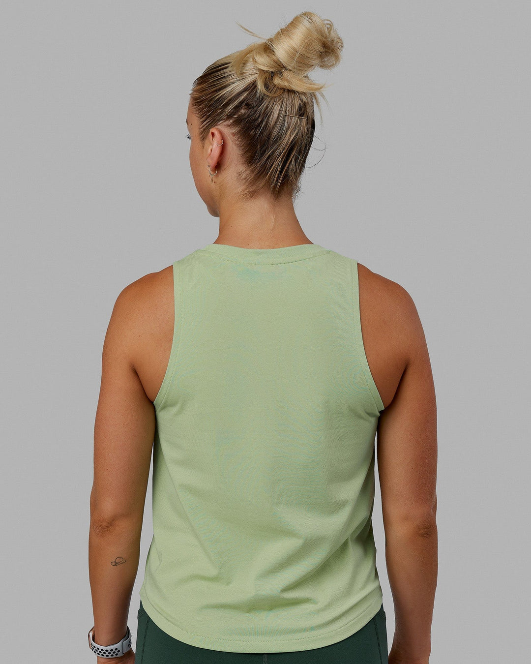 Woman wearing Penalty Tank - Green Fig-Storm