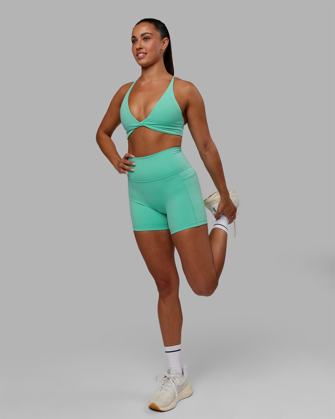 Woman wearing Progression Sports Bra - Aquatic Awe