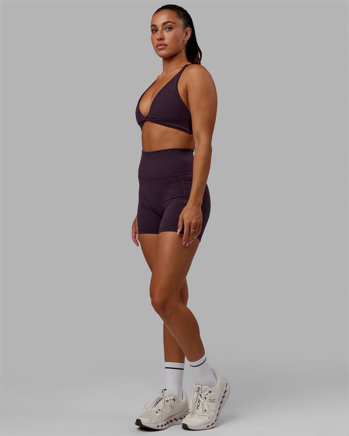 Woman wearing Progression Sports Bra - Midnight Plum
