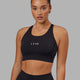 Woman wearing Propel Sports Bra - Black