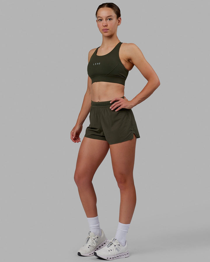 Woman wearing Propel Sports Bra - Forest Night