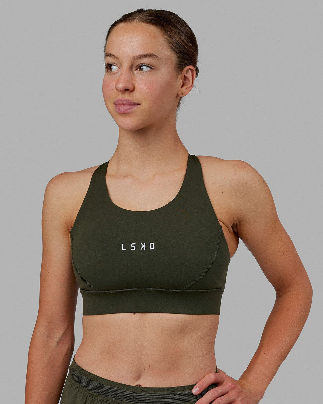 Woman wearing Propel Sports Bra - Forest Night