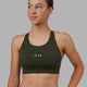 Woman wearing Propel Sports Bra - Forest Night