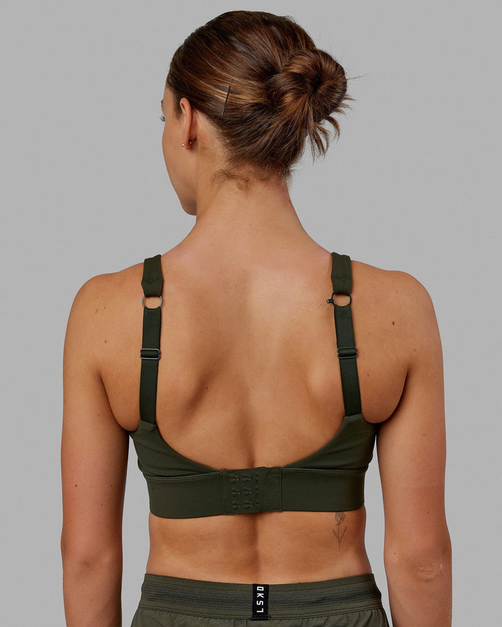 Woman wearing Propel Sports Bra - Forest Night