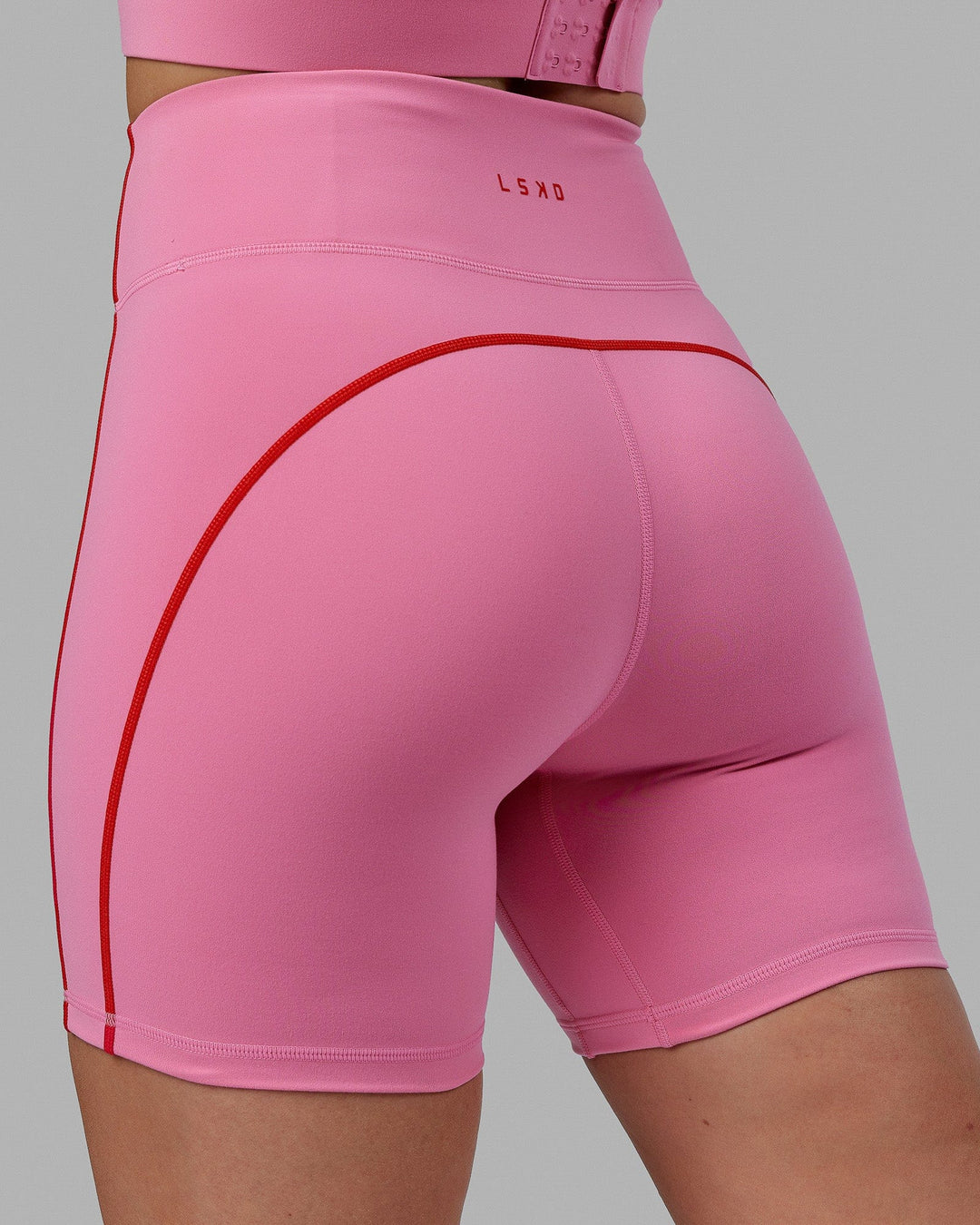 Woman wearing Pulse Mid Short Tights - Pink Rose-Scarlet