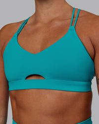 Woman wearing Pursue Sports Bra - Blue Bird
