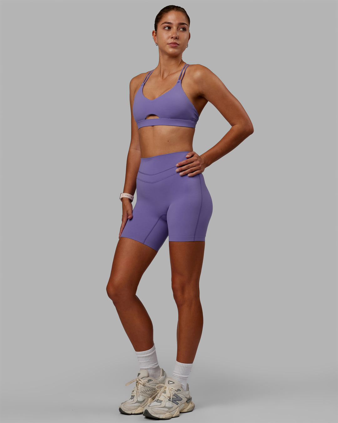 Woman wearing Pursue Sports Bra - Dahlia Purple