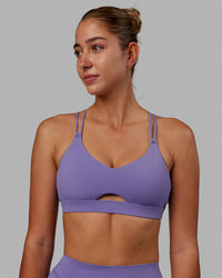 Woman wearing Pursue Sports Bra - Dahlia Purple
