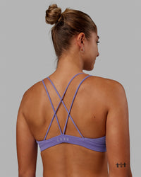 Woman wearing Pursue Sports Bra - Dahlia Purple