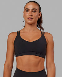 Woman wearing Push The Limit Sports Bra - Black