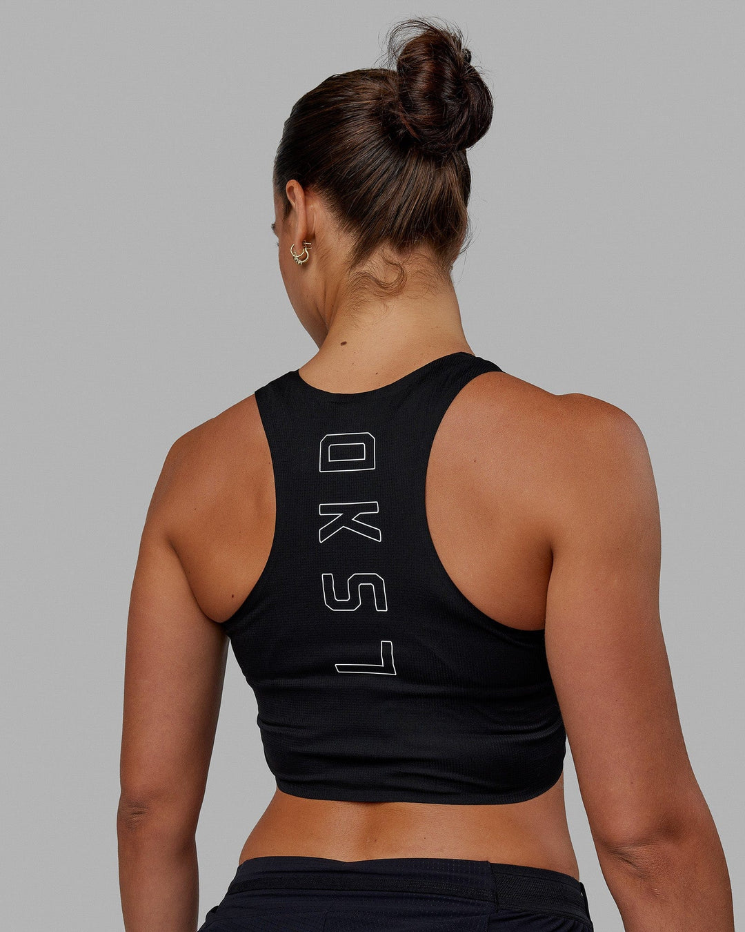 Woman wearing Race Day Cropped Performance Tank - Black-White