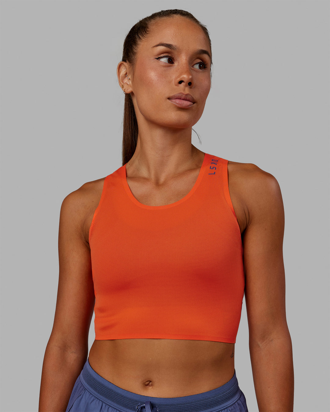 Woman wearing Race Day Cropped Performance Tank - Ultra Orange-Future Dusk