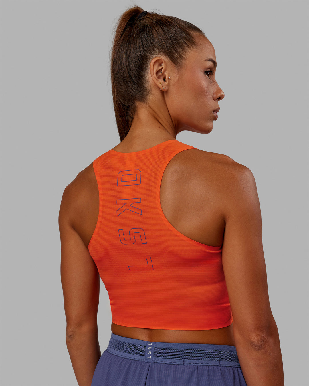 Woman wearing Race Day Cropped Performance Tank - Ultra Orange-Future Dusk
