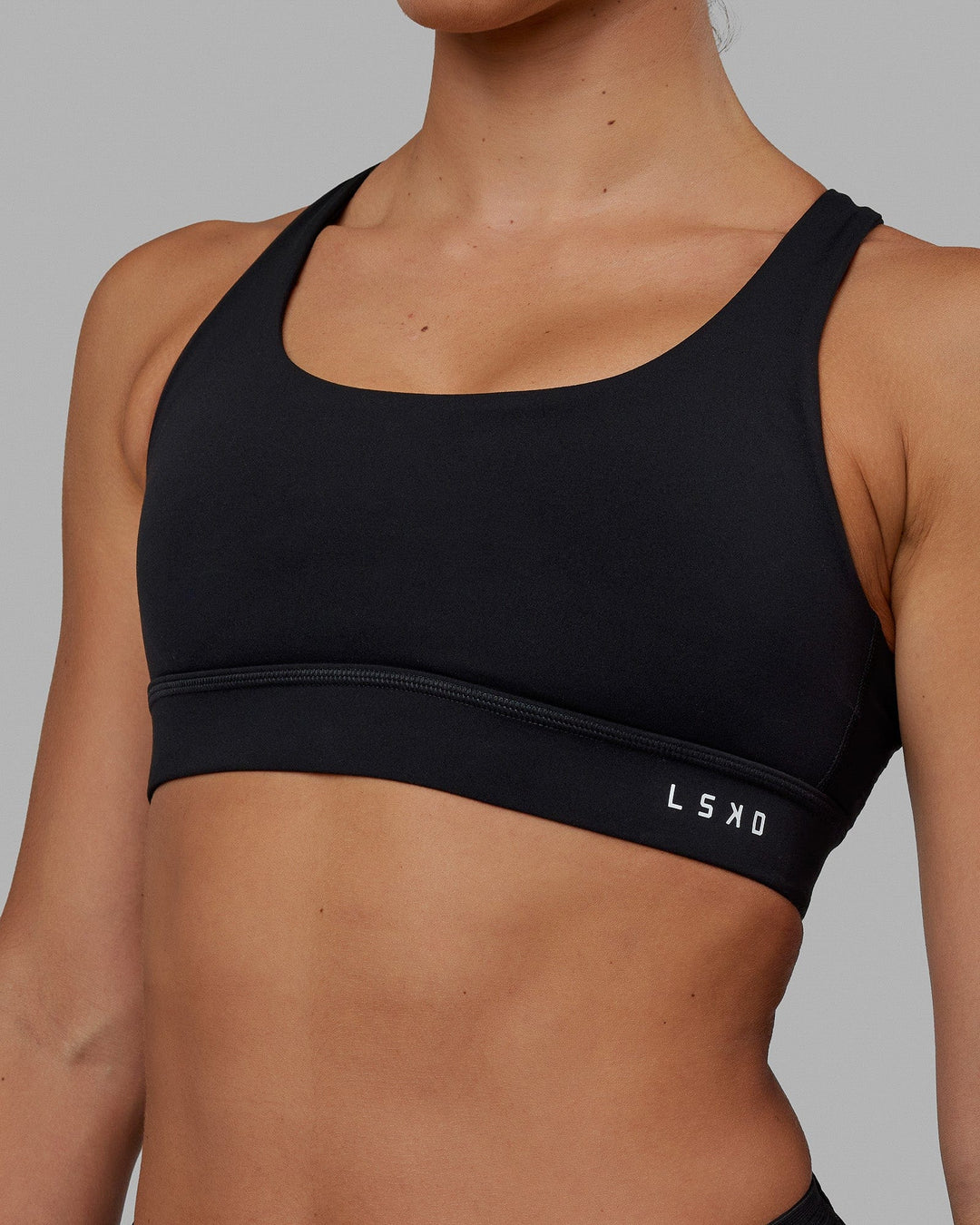 Woman wearing Race Day Sports Bra - Black