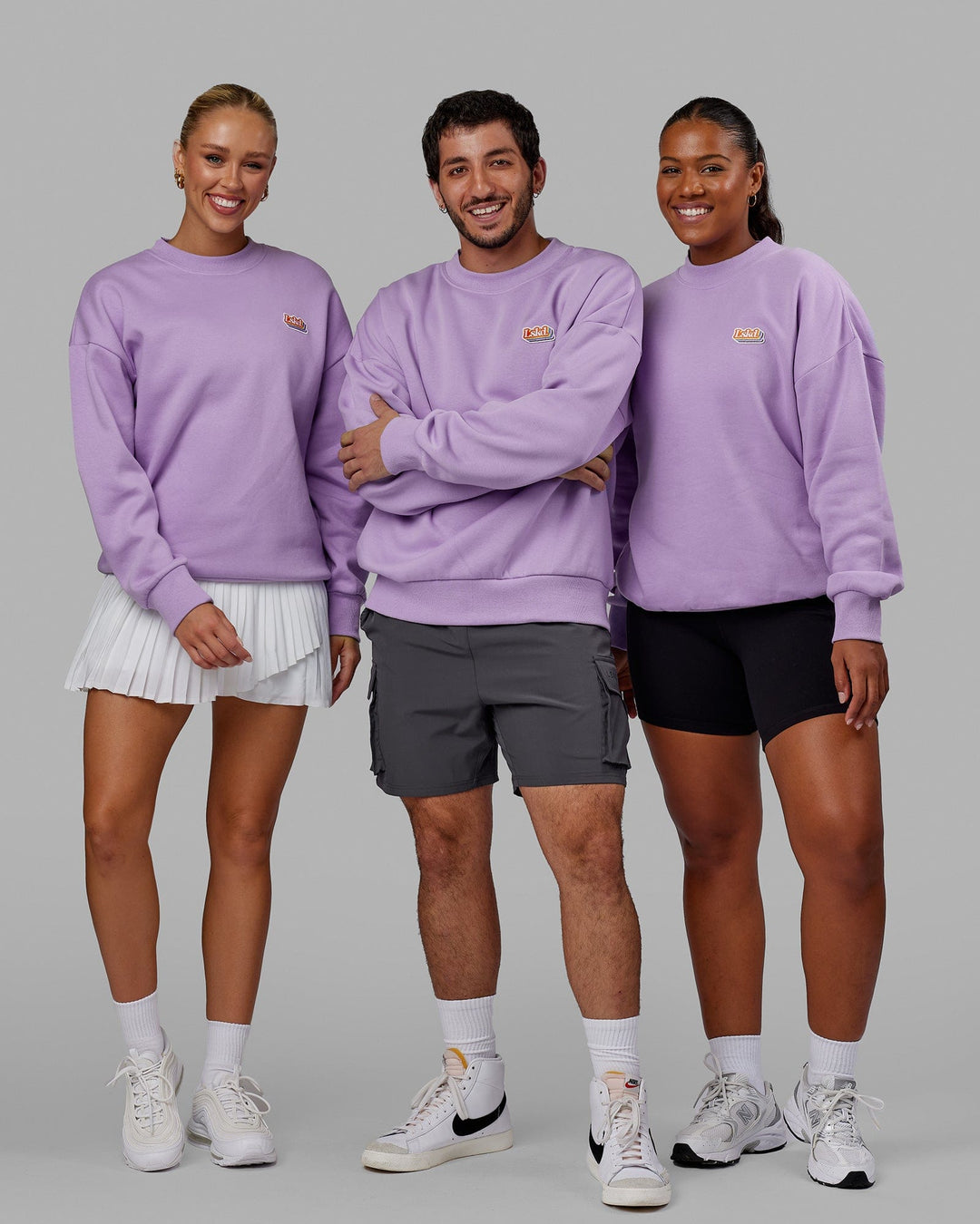 Group wearing Unisex Radiate Sweater Oversize - Pale Lilac