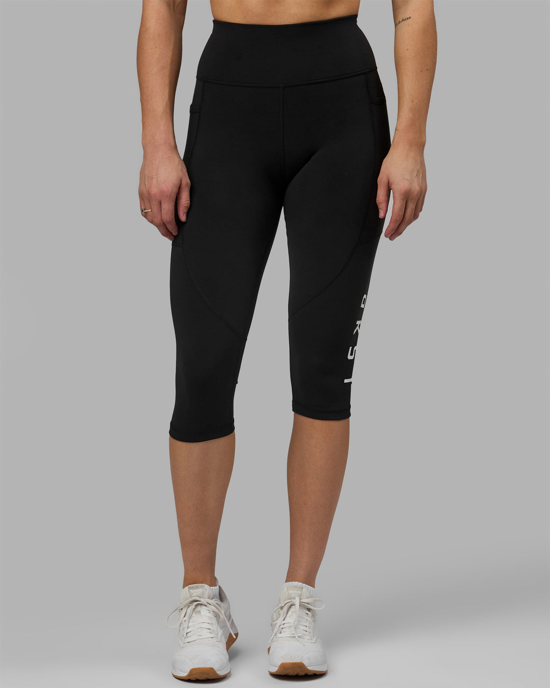 Woman wearing Rep Ultra High-Rise 3/4 Legging Pockets - Black-White | Model:Hannah | Size:S