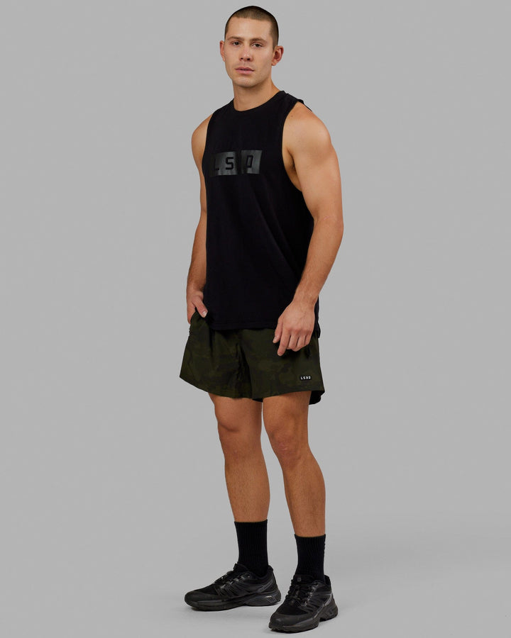 Man wearing Rep 5" Performance Short - Dark Olive Camo