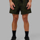 Man wearing Rep 5" Performance Short - Dark Olive Camo