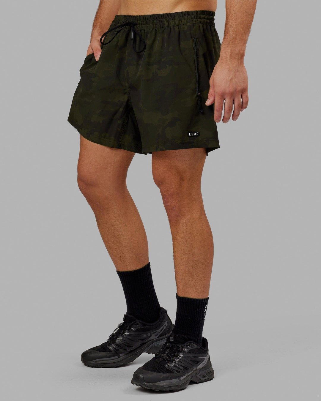 Man wearing Rep 5" Performance Short - Dark Olive Camo