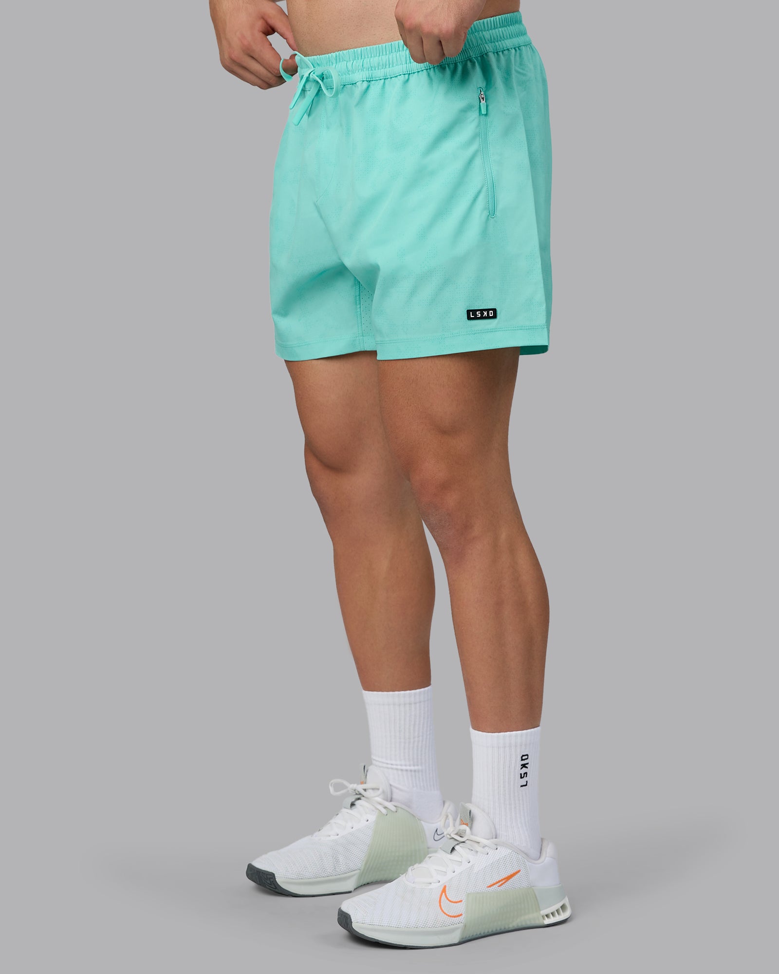 Man wearing Rep 5" Performance Shorts - Digital Camo Cockatoo