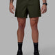 Man wearing Rep 5'' Performance Short - Forest Night-Lime