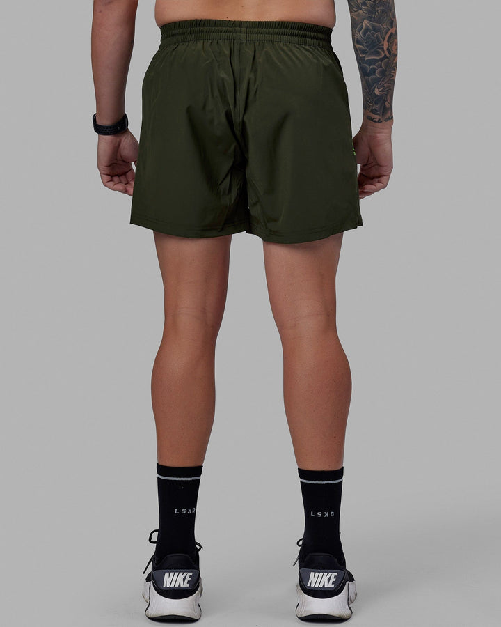Man wearing Rep 5'' Performance Short - Forest Night-Lime