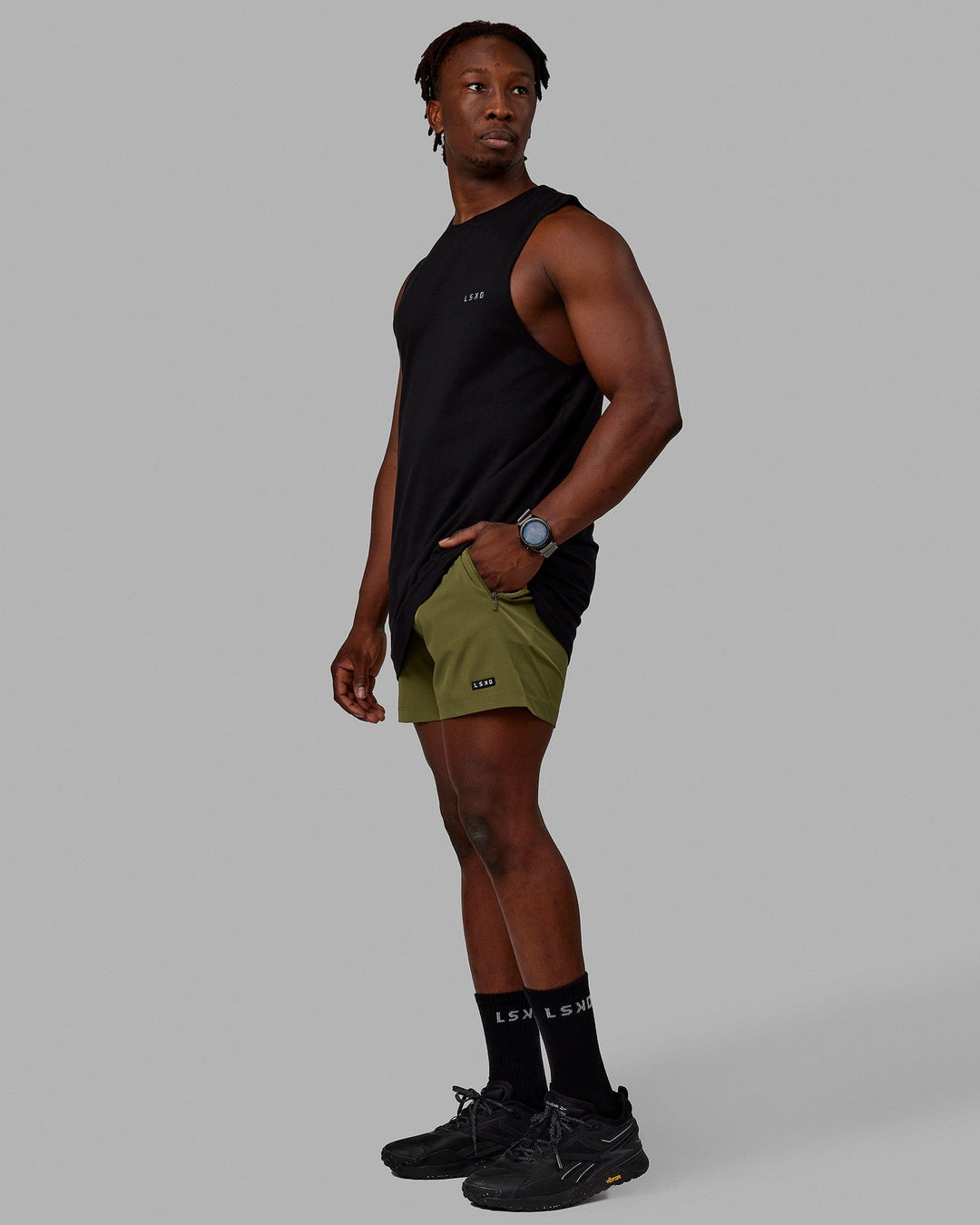 Man wearing Rep 5'' Performance Shorts - Moss