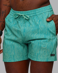 Man wearing Rep 5" Performance Shorts - Topographic Blue Bird