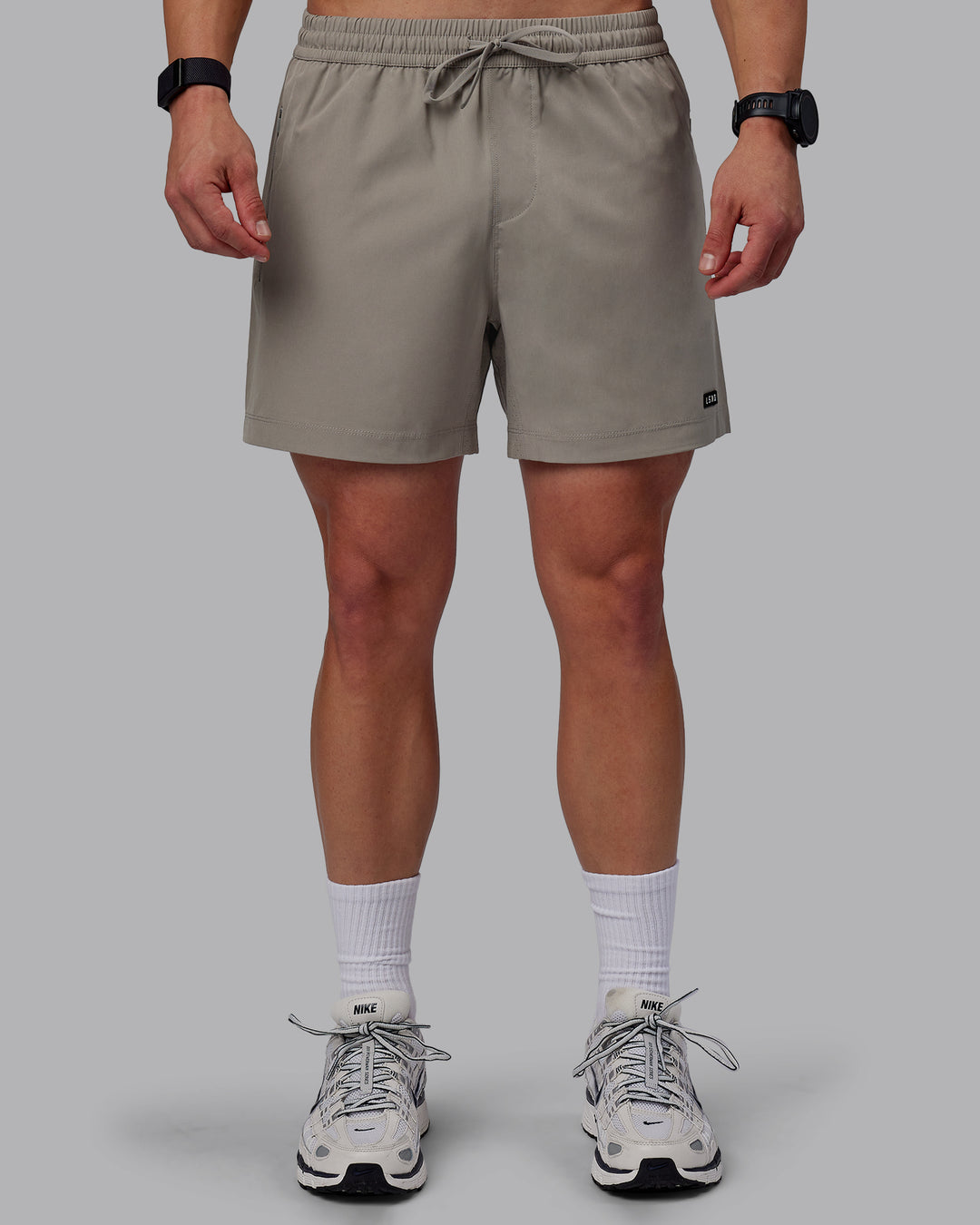 Man wearing Rep 5" Performance Shorts - Elephant