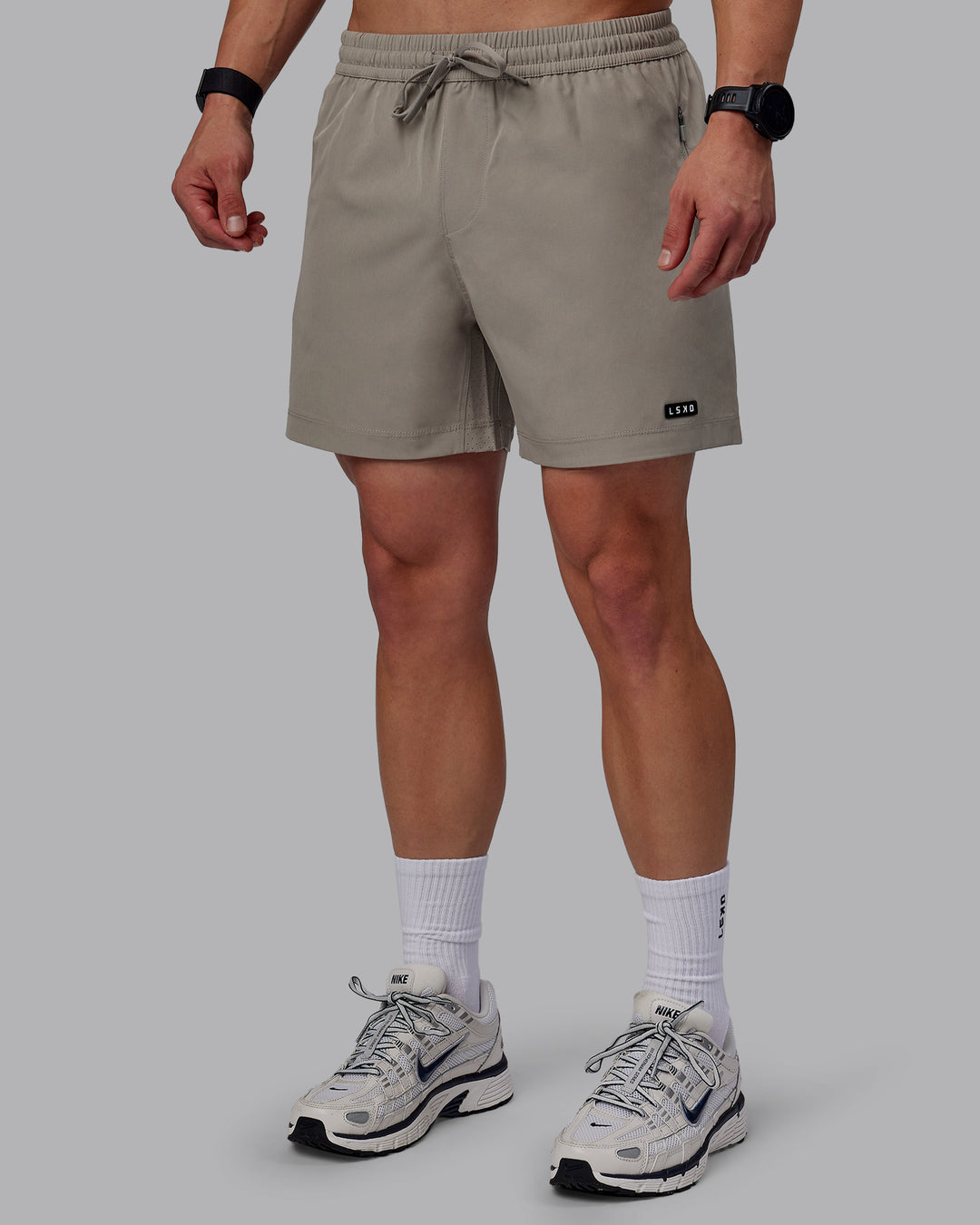 Man wearing Rep 5" Performance Shorts - Elephant