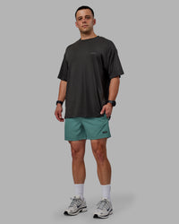 Man wearing Rep 5" Performance Shorts - Sage Bush
