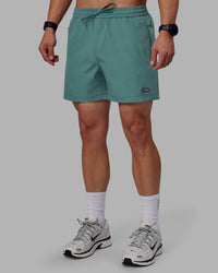 Man wearing Rep 5" Performance Shorts - Sage Bush