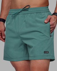 Man wearing Rep 5" Performance Shorts - Sage Bush