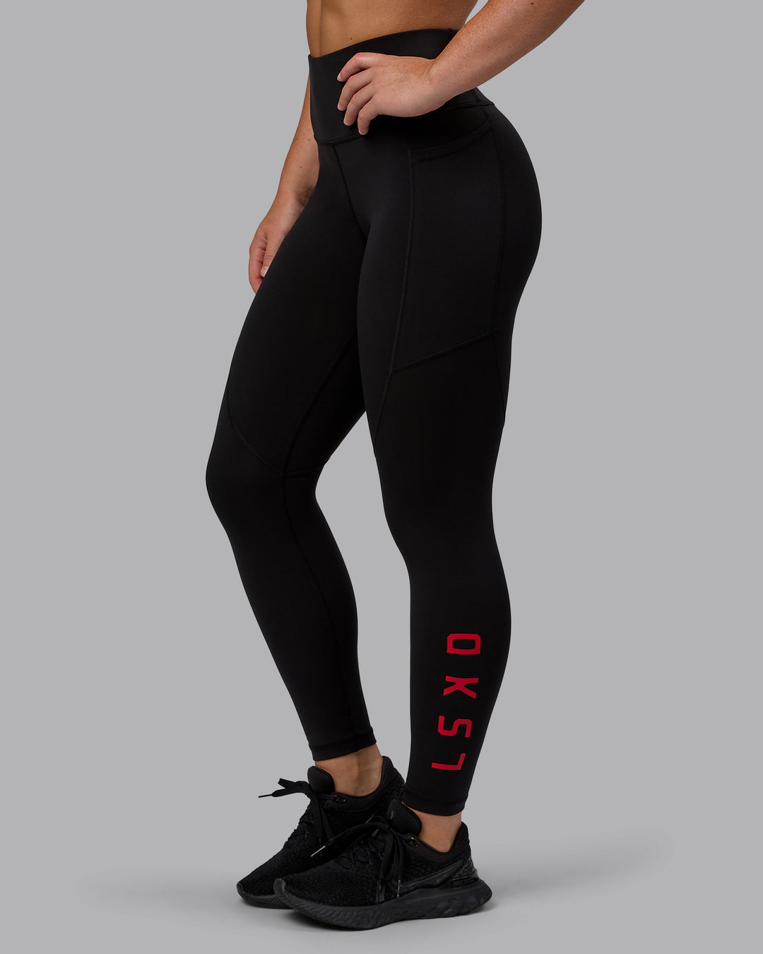 Woman wearing Rep Ultra High-Rise 7/8 Legging Pockets - Black-Crimson | Model:Monique | Size:S
