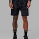 Man wearing Rep 7" Performance Short - Black Camo