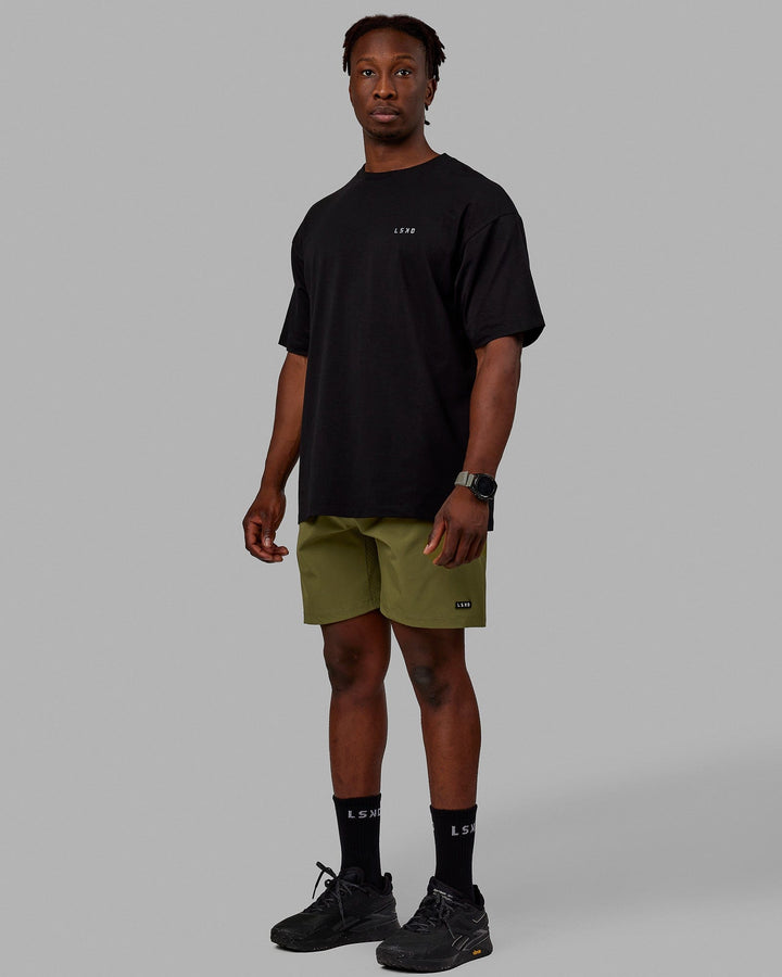 Man wearing Rep 7'' Performance Shorts - Moss