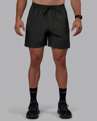Man wearing Rep 7" Performance Shorts - Pirate Black