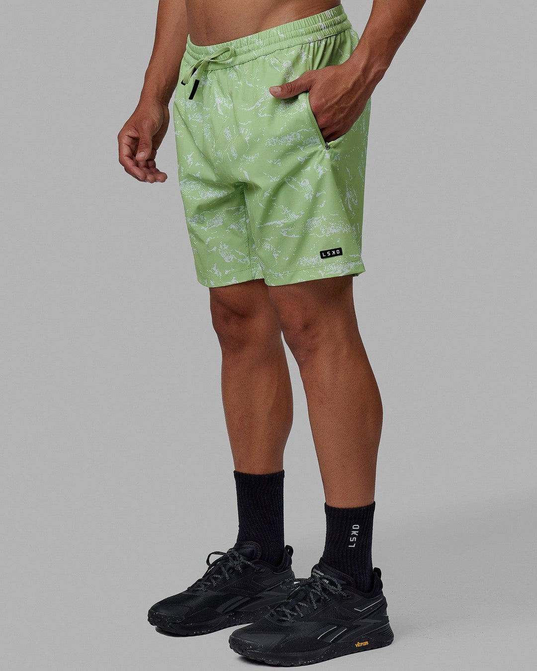 Man wearing Rep 7'' Performance Short - Terrain Green Fig